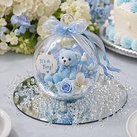 Baby shower fillable ornament centerpiece idea featuring blue flowers and teddy bear decorations for baby shower and nursery décor.